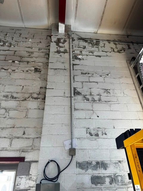 Electrical conduit installed on masonry wall